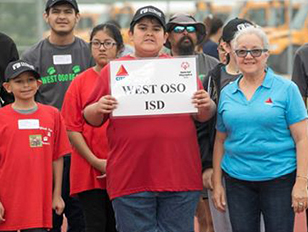 Group of West Oso ISD supporters holding up a West Oso ISD sign